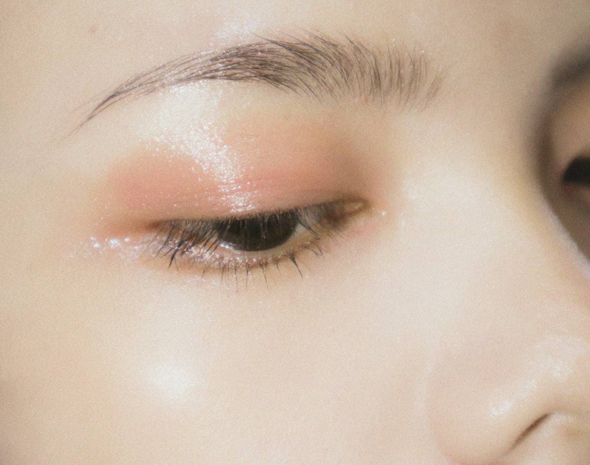 Close-up of textured pigments and unconventional materials used in abstract makeup concept