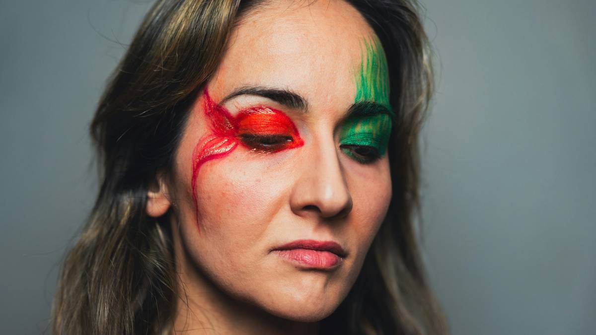 Close-up of model wearing bold experimental eye liner with geometric shapes and vibrant colors