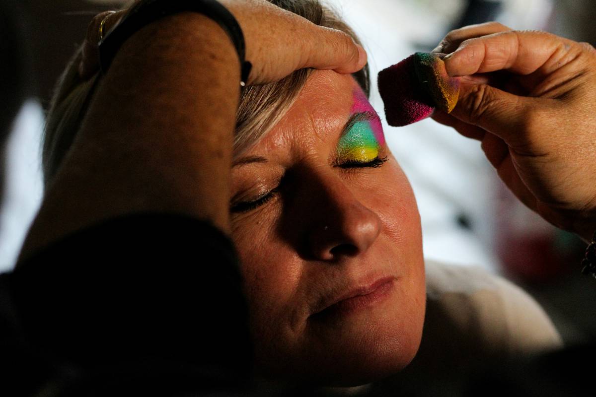 Makeup artist applying innovative lipstick with precision brush for long-lasting wear
