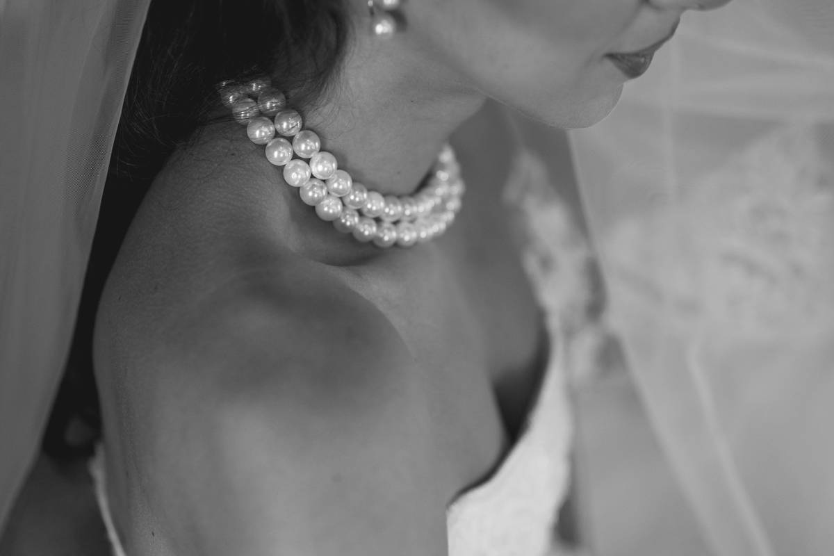 Bridal makeup look featuring dewy skin, defined eyes, and long-lasting lip color on a South Asian bride