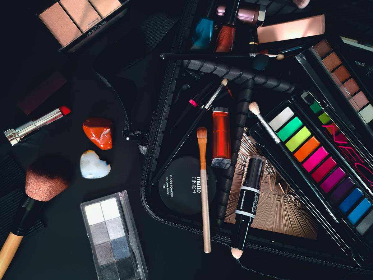 Organized pro makeup kit with labeled compartments, brushes, and foundations arranged neatly